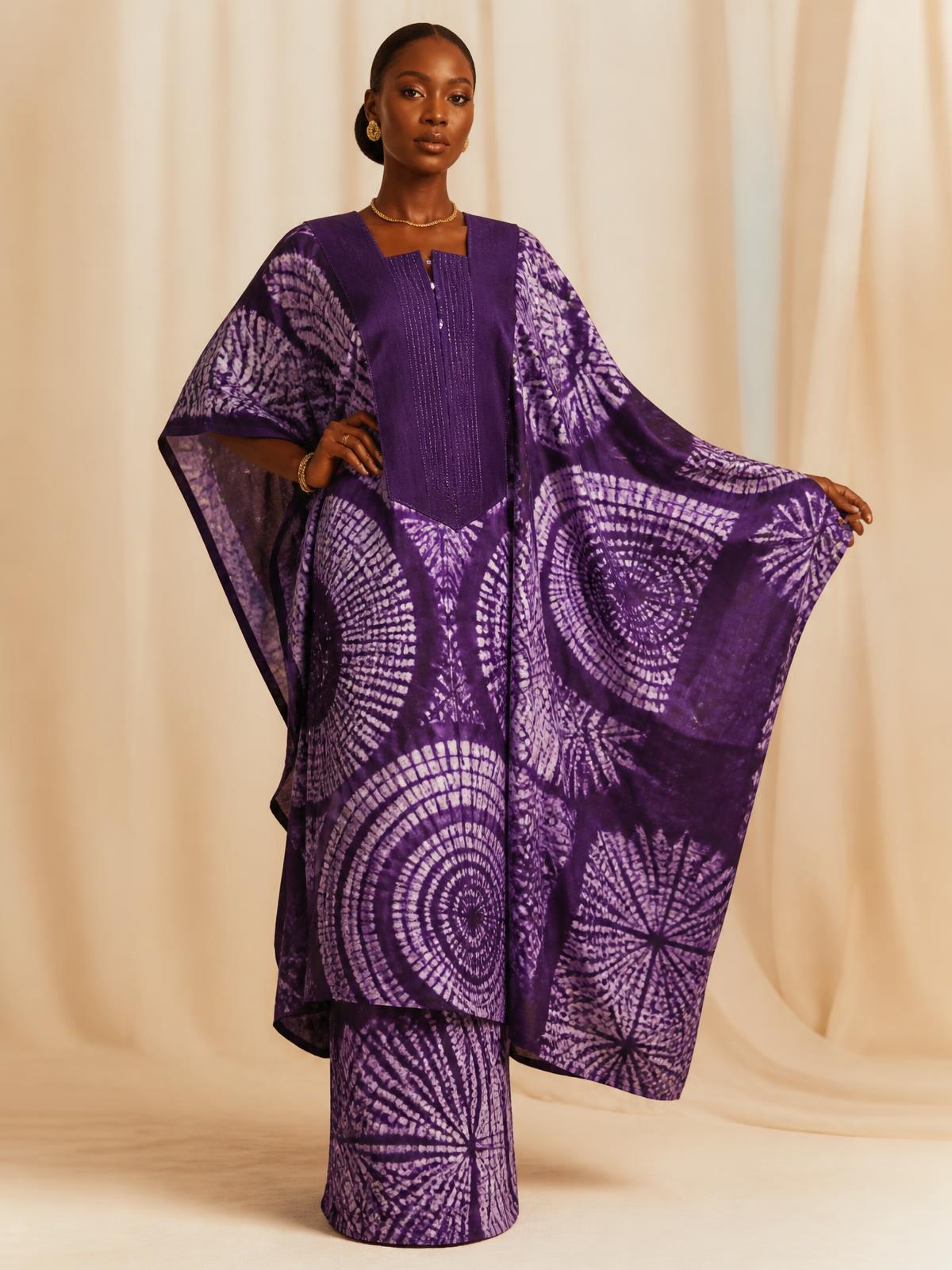 Woman wearing a royal purple Adire outfit from Segi's Royal Fabrics