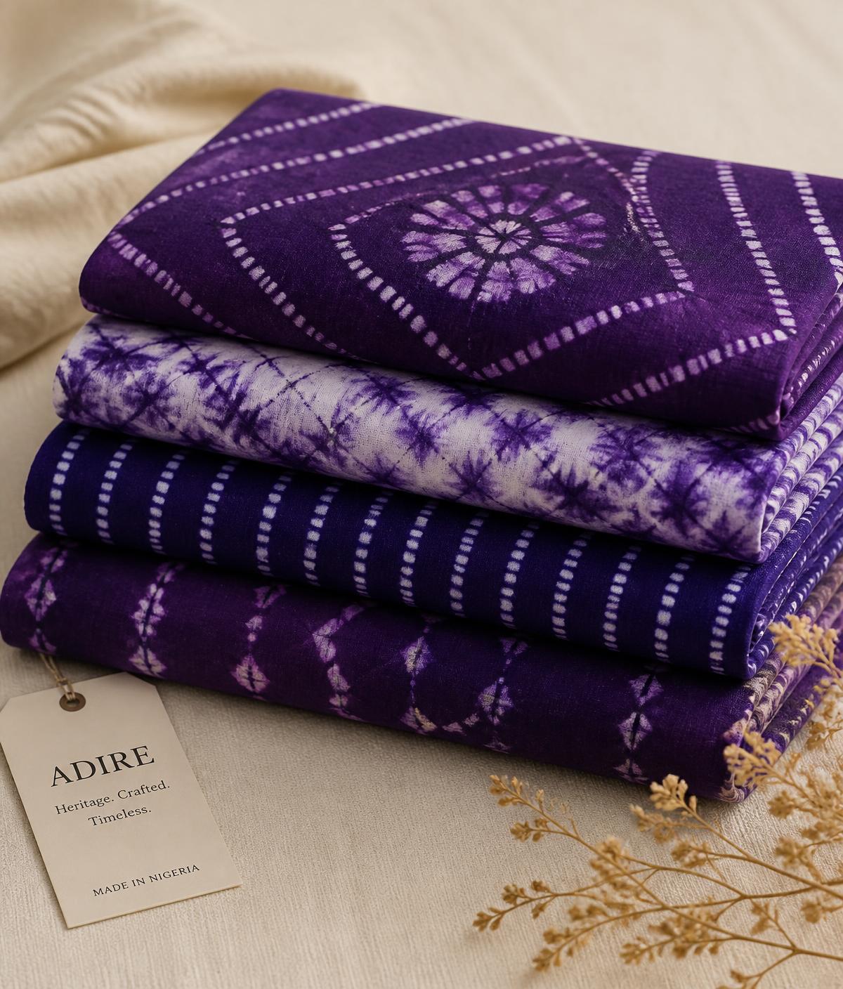 Folded stacks of premium purple Adire fabric made in Nigeria